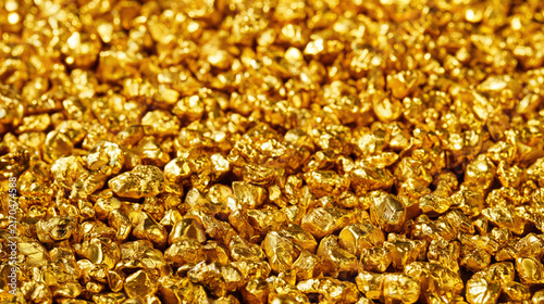 Gold nugget texture close up with shiny metallic surface and rich yellow color