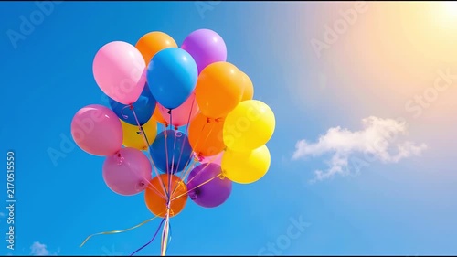 Colorful Balloons Floating Upwards Against a Bright Blue Sky with Sun and Clouds.