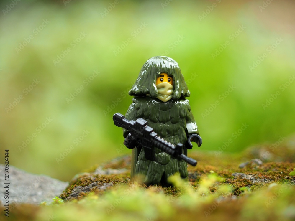 Fototapeta premium Indonesia - May 9, 2023 : Toy photography concept at outdoor with unfocus green grass. Background is blurred.
