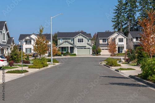 American suburban neighborhood street with modern homes and green landscaping