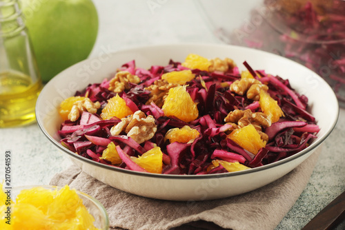 Bild auf Leinwand Red cabbage salad with oranges and walnuts - a traditional dish of Norwegian cui