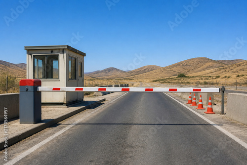Empty road checkpoint with lowered red and white barrier arm, guard booth and cones, security and traffic control concept