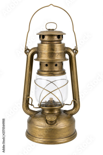 Foto Antique brass oil lantern with a glass globe and wick stands upright, isolated o