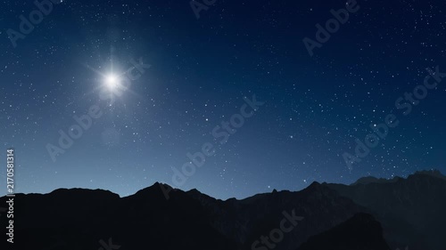 Glowing Christmas star above a peaceful mountain landscape with night sky