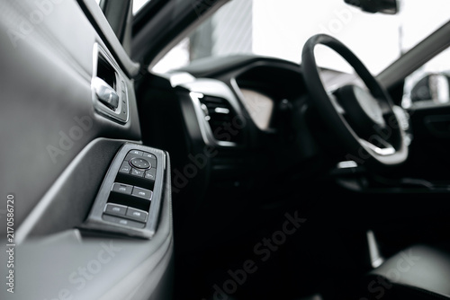 фотографія Close view of a premium car interior with a multifunction steering wheel and central control console