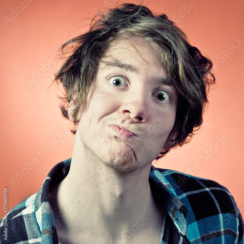 Man making pulling funny faces, portrait