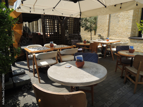Empty Dining Tables and Chairs on Outdoor Restaurant Patio
