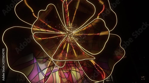 Illuminated sculptural flower installation with glowing golden petal edges and sparkling filament core shot from low closeup, with flower, sculpture, installation,petal detail