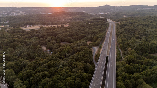 Highway passing through forests at sunset in Allariz