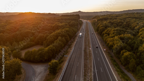 Highway traversing forest at sunset in Allariz, Ourense, Spain