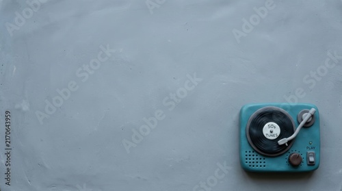 Blue record player on gray surface.