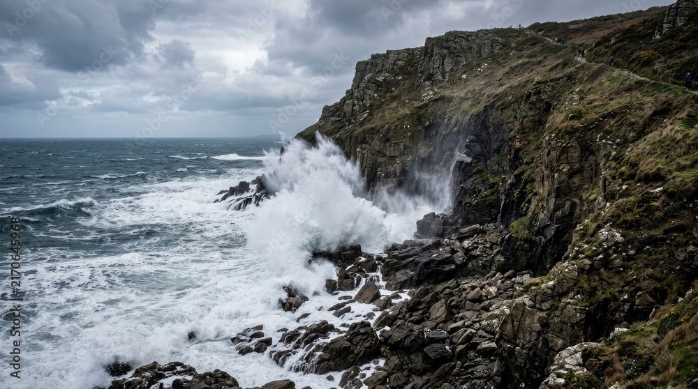 Fototapeta premium The crashing waves visible from the rocky edge of the beach.