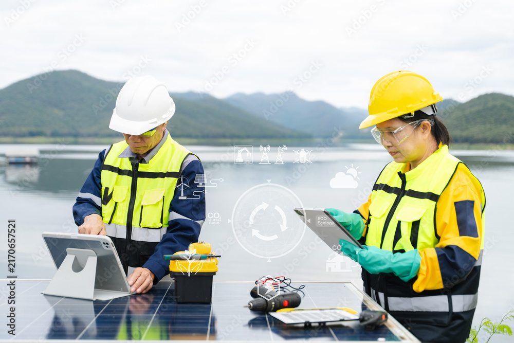 Fototapeta premium Asian engineers use a digital tablet with eco icons overlay to manage solar panel renewable energy and carbon