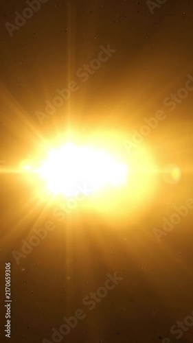 Bright golden sun flare with light leaks on dark background