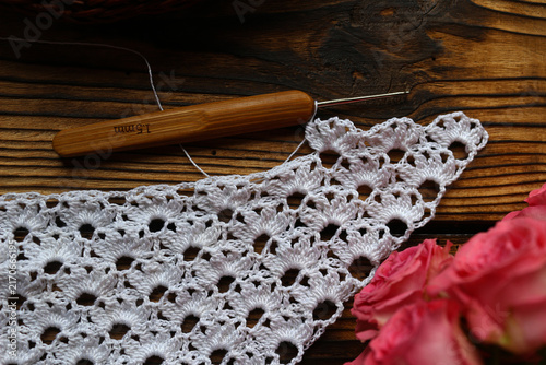 Fotografía Elegant handmade white crochet lace openwork work in progress with pink roses and 1