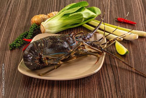 Obraz na plátně Fresh lobster with bok choy ginger lime and lemongrass on wooden table