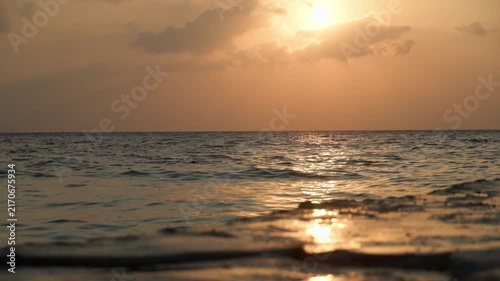 Golden sunset over calm ocean horizon