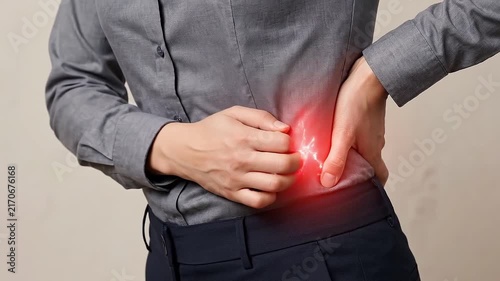 Lower Back Pain in Adult Human, Hand Pressing Lumbar Spine with Discomfort and Red Inflammation, Side View Showing Muscle Strain, Indoor Healthcare Concept with Concern and Copy Space
