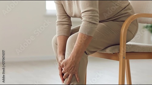 Knee Pain Osteoarthritis Joint Discomfort Limits Mobility for Older Adult Seated Indoors, Supporting Sore Knee During Daily Life and Highlighting Chronic Mobility Difficulty