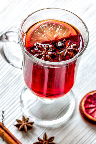 Foto mulled wine with spices in cup on wooden background