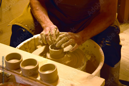 фотографія The master potter shapes earthenware on a pottery wheel, creating an authentic hand-made process