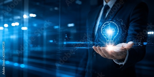 Businessman holding glowing light bulb in palm representing idea, innovation, and inspiration with abstract technology background.