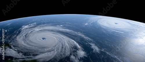Two powerful tropical cyclones over the ocean seen from orbit, representing simultaneous hurricanes, severe weather monitoring, storm warnings and emergency planning