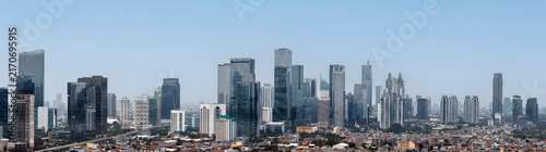 Panoramic view of the modern Jakarta city skyline with skyscrapers and urban residential areas under a clear sky. Jakarta, Indonesia. Cityscapes background