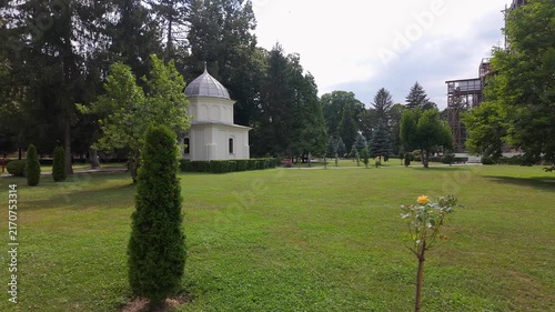 Small domed building in landscaped grounds of Curtea de Arges Monastery, Arges County, Romania