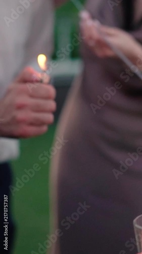 Sparklers explode during the evening celebration. People hold fireworks during the New Year's or Birthday celebration.