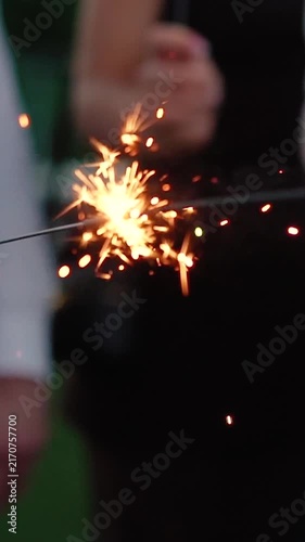 Sparklers explode during the evening celebration. People hold fireworks during the New Year's or Birthday celebration.