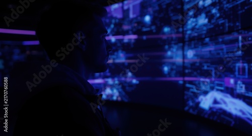 Immersive Technology: Person silhouette viewing a panoramic digital screen wall inside an interactive exhibition 