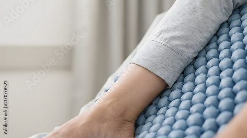 Healthcare worker checking pressure areas on an adult patient lying