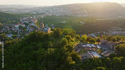 Aerial view Tsarevets fortress Patriarchal Cathedral Veliko Tarnovo historic stronghold golden hour sunset backlighting travel destination Bulgaria Europe