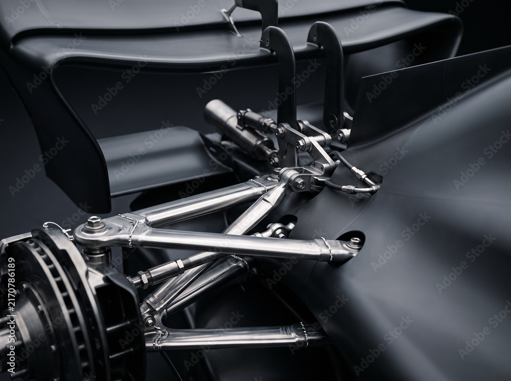 Fototapeta premium close up detail shot of sports racing car front wheel suspension wishbones brake disc assembly and carbon fiber elements displaying high performance engineering components and layout