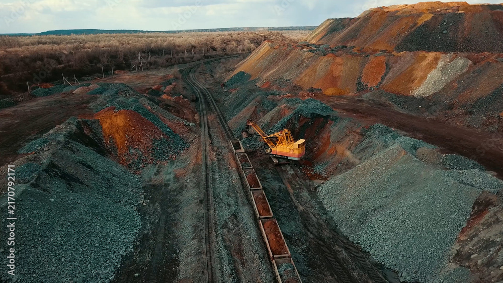 Fototapeta premium Iron ore quarry loading and transportation, aerial view