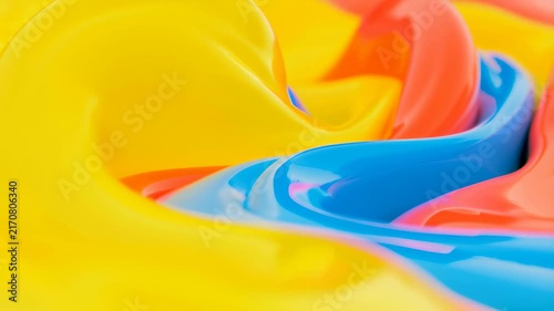 Close-up animation of glossy yellow, blue, and red liquid paint swirling and mixing. Abstract backdrop shaped by flowing motion, fluid dynamics and color mixing.