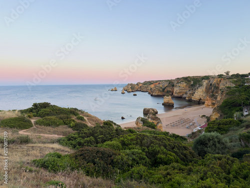 Scenic beach cove with rock formations at sunset in Algarve