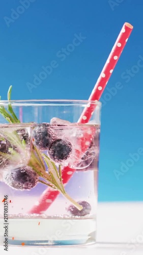 Animation of confetti falling and cocktail on blue background