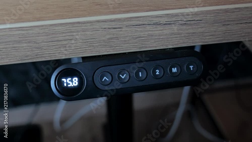 Electric standing desk control panel in modern home office