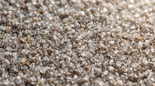 Crushed quartz texture background. Macro shot of sparkling mineral sand and gravel.