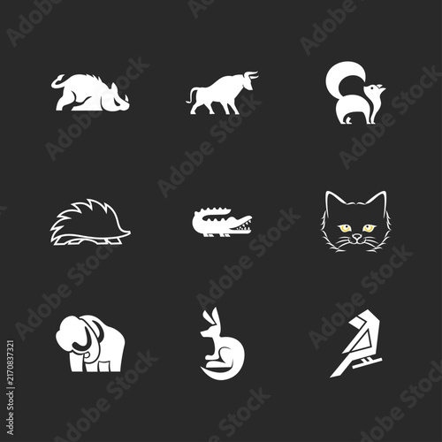 Collection of Diverse Animal Vector Icons: Wild Boar, Bull, Skunk, Hedgehog, Alligator, Cat, Elephant, Kangaroo, and Bird Silhouettes on Dark Background.