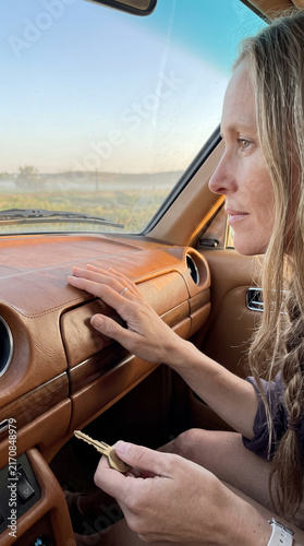 Woman recovering  from trauma starting a car for first time