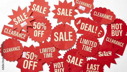 A collection of red sale and clearance tags isolated on white background