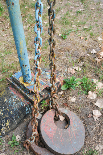 Brutal heavy chains and iron counterweights on backyard street gym