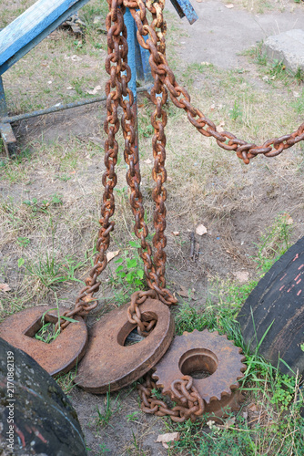 Brutal homemade steel counterweights and heavy rusty chains on the ground