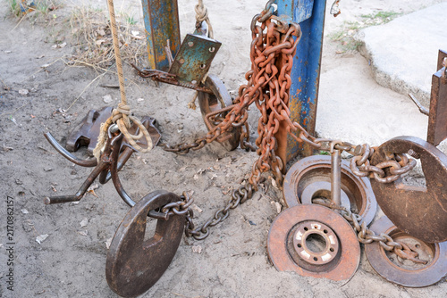 Brutal homemade counterweights and heavy rusty chains on outdoor gym machinery