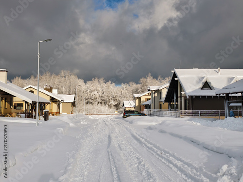 Snow-covered, uncleared road in a siberian cottage village.
