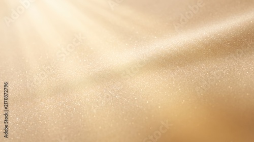Abstract shimmering gold texture with soft light rays and sparkling glitter particles, elegant luxury surface for design overlays, wedding invitations, festive holiday cards