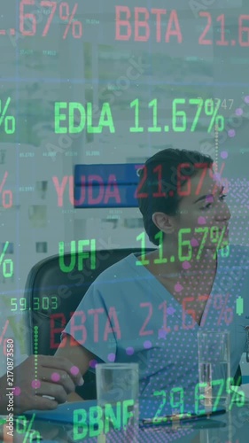 Animation of trading board and graphs moving over caucasian doctors discussing reports in meeting